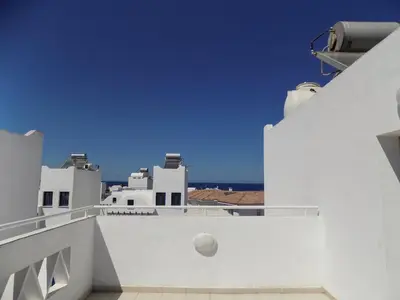a view from the balcony of a white building at Olive Tree Villa - Protaras in Protaras