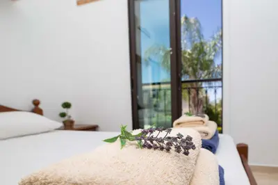 a bed with a blanket and towels on it at Mylos 9 in Protaras