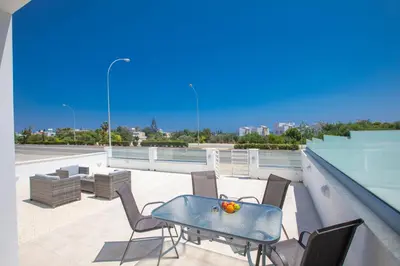 a patio with a table and chairs on a roof at Panayia Sea View Apts in Protaras