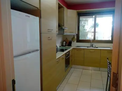 a kitchen with a white refrigerator and a window at Apartment Sleeps 6 with Ensuite in Nicosia