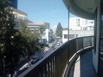 a balcony of a building with a view of a street at Apartment Sleeps 6 with Ensuite in Nicosia