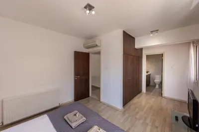 a large living room with white walls and wooden floors at Villa Adalia in Protaras
