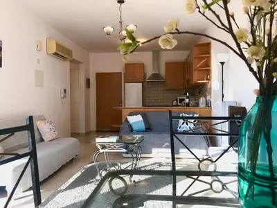 a living room with a couch and a table at 1 bedroom flat, prime location near sea, sleeps 4 in Limassol