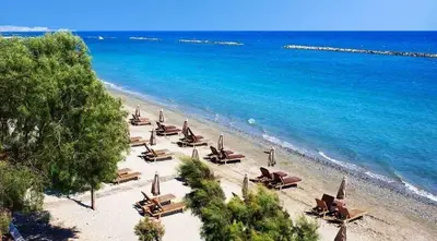 an overhead view of a beach with chairs and the ocean at 1 bedroom flat, prime location near sea, sleeps 4 in Limassol