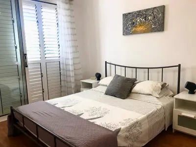 a bedroom with a bed and a window at 1 bedroom flat, prime location near sea, sleeps 4 in Limassol