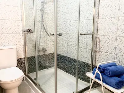 a bathroom with a shower and a toilet at 1 bedroom flat, prime location near sea, sleeps 4 in Limassol