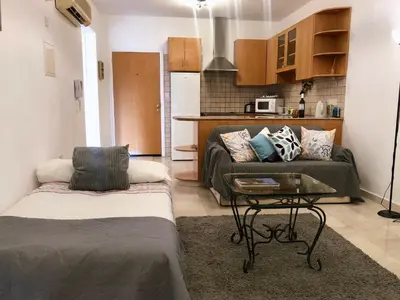 a living room with a couch and a table at 1 bedroom flat, prime location near sea, sleeps 4 in Limassol