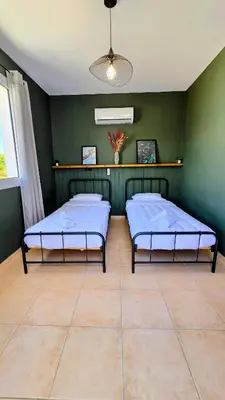 two beds in a room with green walls at Sweet Destiny Villa with private pool in Ayia Napa