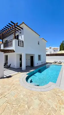 a white house with a swimming pool in front of it at Sweet Destiny Villa with private pool in Ayia Napa