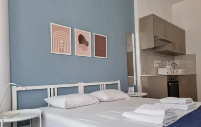 a bedroom with a white bed with towels on it at Tefkrou Anthia 9 apts in Ayia Napa
