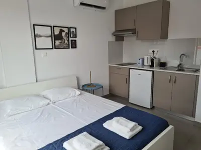 a bedroom with a bed with two towels on it at Tefkrou Anthia 9 apts in Ayia Napa