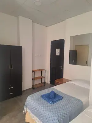 a bedroom with a bed with a blue hat on it at TERPSICHORE Holiday Apts in Limassol