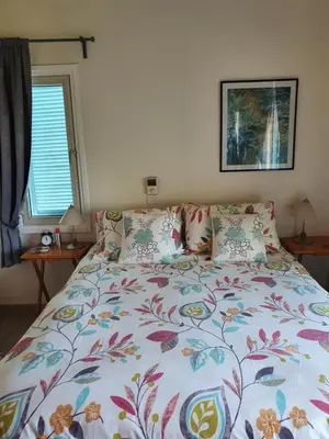 a bedroom with a bed with a floral bedspread at Melanta Villa in Pissouri