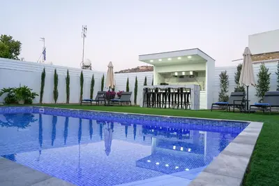 a swimming pool in the backyard of a house at Kamaroporta Luxury Apartments in Ayios Theodhoros