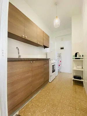 a kitchen with wooden cabinets and a sink at Simple One bedroom flat in Engomi in Engomi