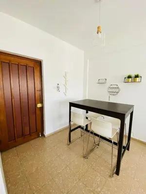 a black table and chairs in a room with a door at Simple One bedroom flat in Engomi in Engomi