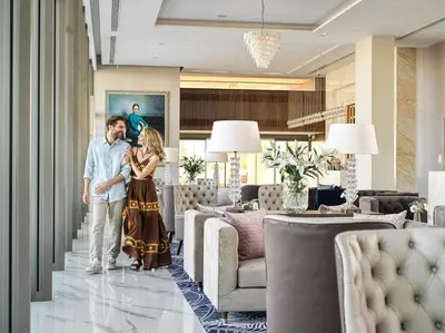a man and a woman standing in a living room at Amanti, MadeForTwo Hotels - Ayia Napa in Ayia Napa