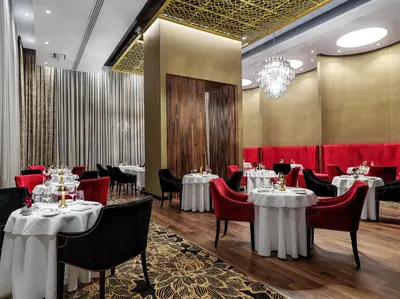 a dining room with tables and chairs and a chandelier at Amanti, MadeForTwo Hotels - Ayia Napa in Ayia Napa
