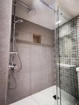 a shower with a glass door in a bathroom at 7Kamares in Pano Lefkara