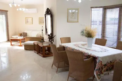 a living room with a table with chairs and a couch at VillaHoliday in Voroklini