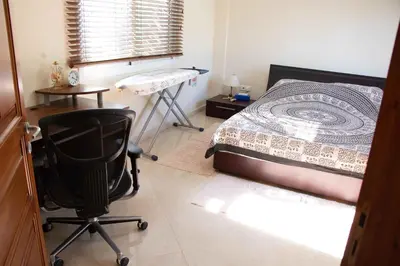 a bedroom with a bed and a desk and a chair at VillaHoliday in Voroklini