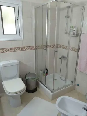 a bathroom with a shower and a toilet and a sink at VillaHoliday in Voroklini