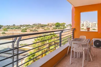 a balcony with a table and chairs and a view at Mirabella Mackenzie 1 Bedroom Flat Near the Sea in Larnaka