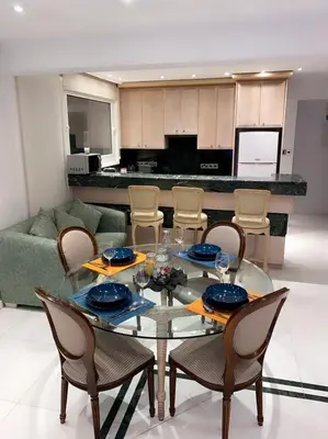 a glass table and chairs in a living room at Larnaca Room, 50m to the Finikoudes beach in Larnaka