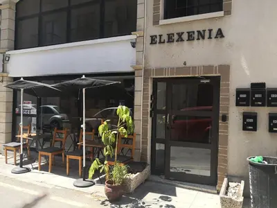 a restaurant with tables and umbrellas on the street at St Lazaros, Larnaca Center Studio in Scala