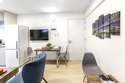 a kitchen and dining room with a table and chairs at C-Premium Apts 100m from beach and city centre in Larnaka