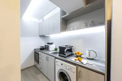 a kitchen with a washer and dryer on a counter at C-Premium Apts 100m from beach and city centre in Larnaka