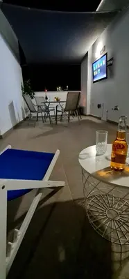 a room with a table and chairs and a television at Spiros Luxury Apartments in Ayia Napa