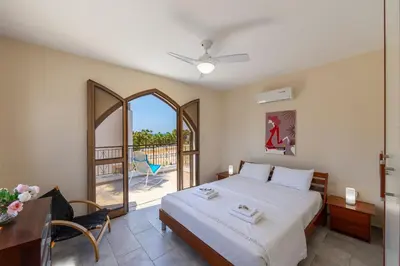 a bedroom with a bed and a balcony at Protaras Villa Elena 3 in Protaras