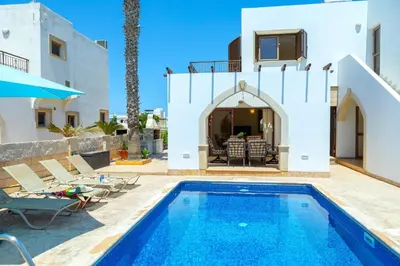 a villa with a swimming pool and a house at Protaras Villa Elena 3 in Protaras