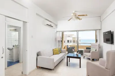 a living room with a couch and chairs and a table at Apollon Sea View Beachfront Ap 302 in Larnaka