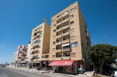 a tall building on the side of a street at Apollon Sea View Beachfront Ap 302 in Larnaka