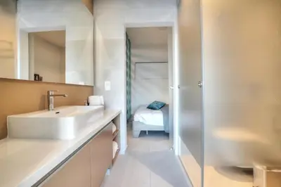 a bathroom with a sink and a mirror at SunnyVillas: NEW Studio SPA & GYM in Kapparis in Protaras