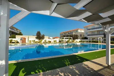 a large swimming pool with blue water at SunnyVillas: NEW Studio SPA & GYM in Kapparis in Protaras
