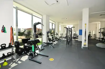 a gym with tread machines and skis in a room at SunnyVillas: NEW Studio SPA & GYM in Kapparis in Protaras