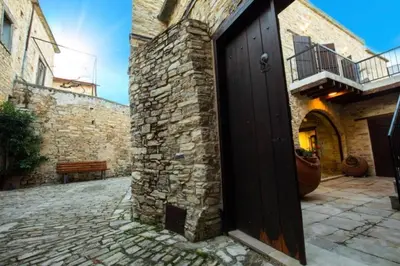 a door to a brick building with a stone courtyard at Whitestone Mill in Pano Lefkara