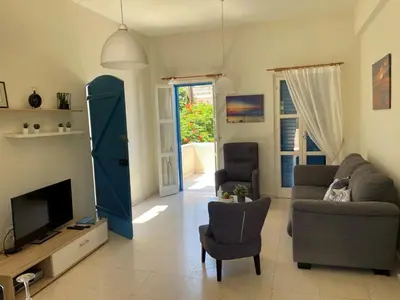 a living room with a couch and a tv at Vitamin Sea Protaras in Protaras