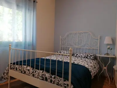 a bedroom with a bed with a blue and white bedspread at House de Fountas in Khandria