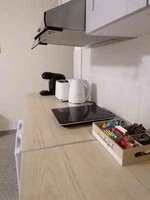 a kitchen with a counter top with a stove top at Pissouri Image in Pissouri