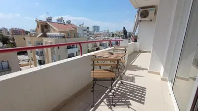 three chairs sitting on a balcony with a view of a city at 5 min to the Beach Holiday Shared Apartment - private ROOM in 3 bdr Apt in Larnaka