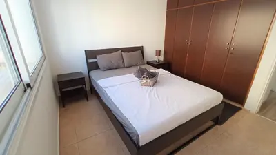 a bedroom with a bed with a basket on it at 5 min to the Beach Holiday Shared Apartment - private ROOM in 3 bdr Apt in Larnaka