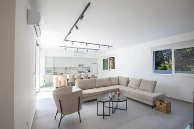 a living room with a couch and a table at Kube Luxury Villas in Ayia Napa