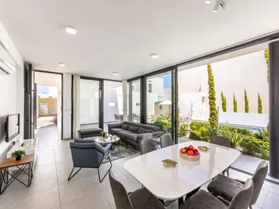 a living room with a white table and chairs at Almaria Residences in Paralimni