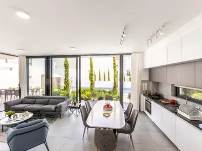 a kitchen and living room with a table and chairs at Almaria Residences in Paralimni