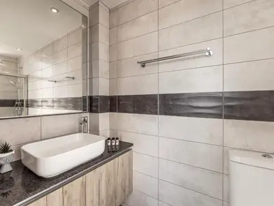 a bathroom with a tub and a sink and a toilet at Almaria Residences in Paralimni