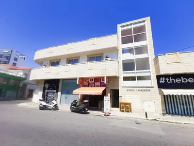 a building with two scooters parked in front of it at FlipFlop City Center Apartment in Larnaka